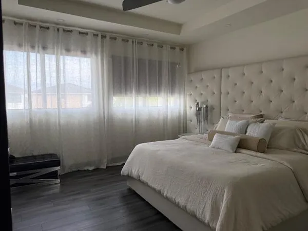 a bedroom with a bed and a mirror