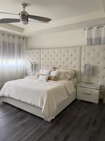 a bedroom with bed and window