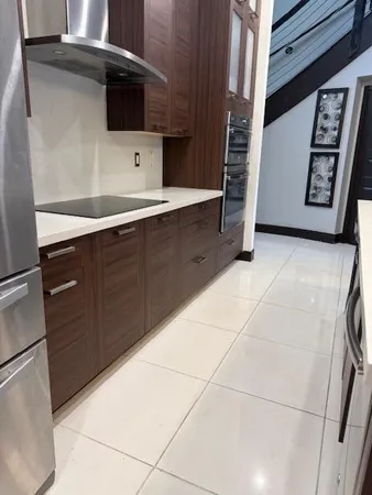 a kitchen with a cabinets and a stove top oven
