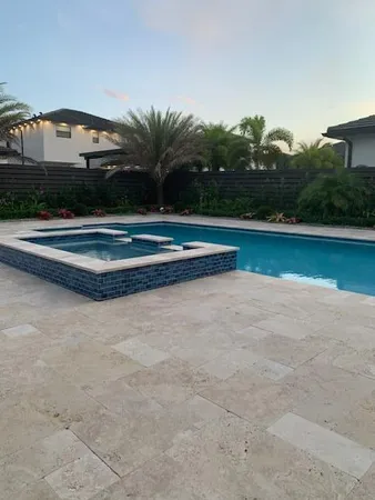 a view of swimming pool with outdoor seating and yard in back