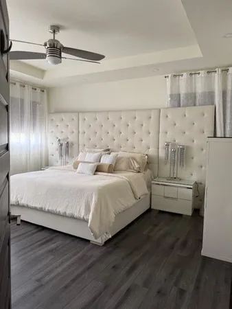 a bedroom with a bed and a view of kitchen