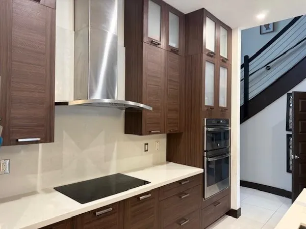 a kitchen with a refrigerator and a stove