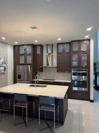 a large kitchen with a table and chairs