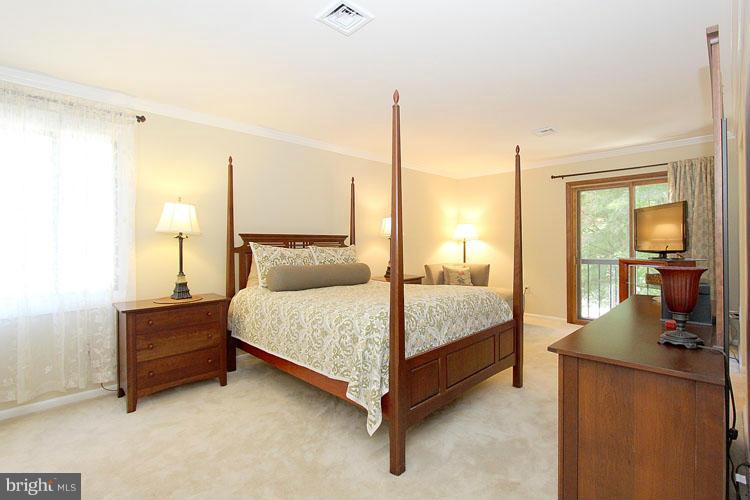 11803 Foxclove Road Reston, VA 20191 - Photo 14 of 30 a bedroom with a bed and large mirror