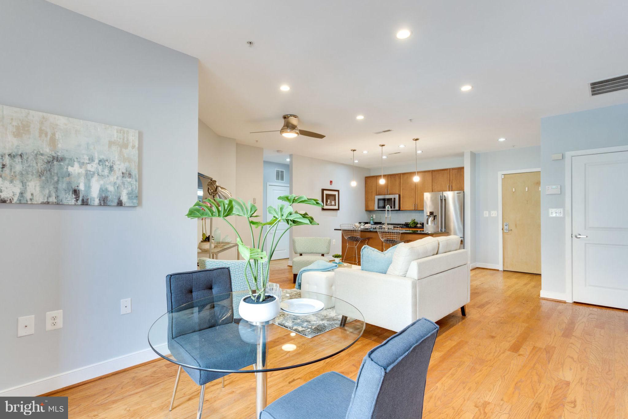 181 East Reed Avenue, Unit 109 Alexandria, VA 22305 - Photo 1 of 30 a living room with furniture kitchen view and a table