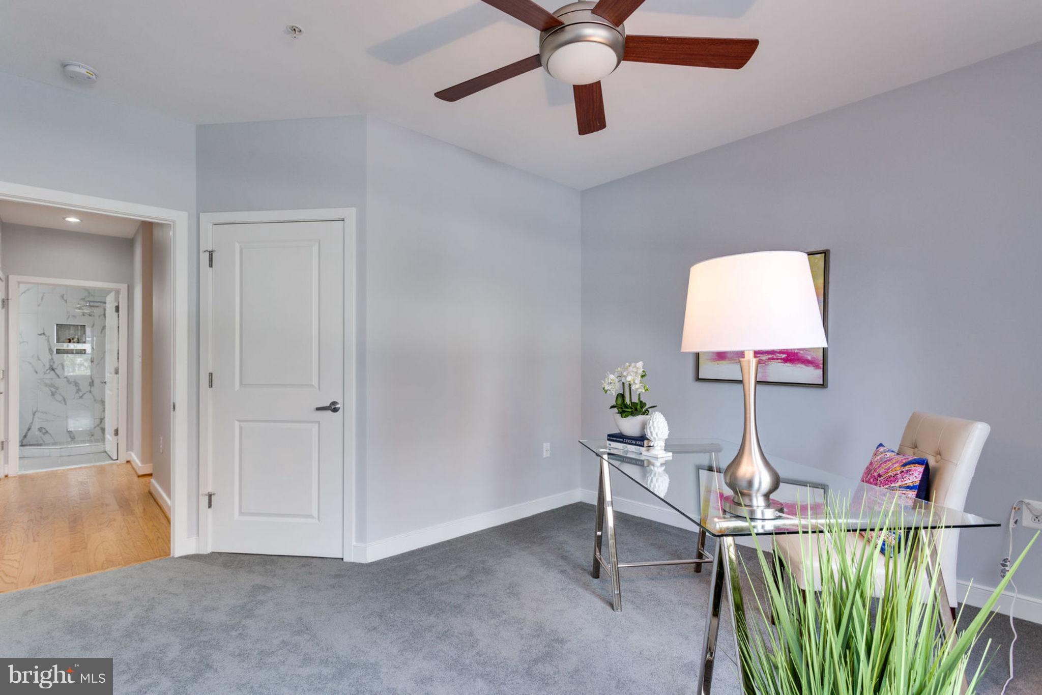 181 East Reed Avenue, Unit 109 Alexandria, VA 22305 - Photo 14 of 30 a living room with furniture and a wooden floor