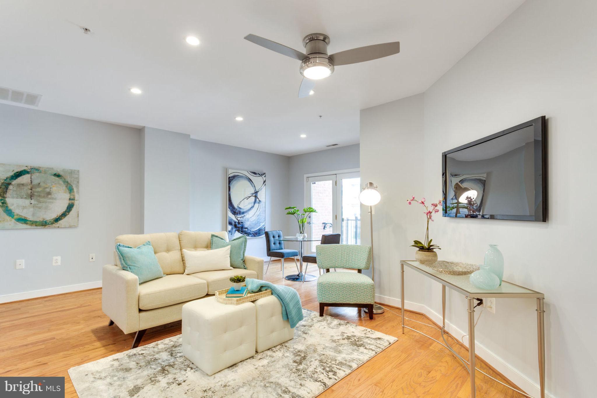 181 East Reed Avenue, Unit 109 Alexandria, VA 22305 - Photo 18 of 30 a living room with furniture and a wooden floor