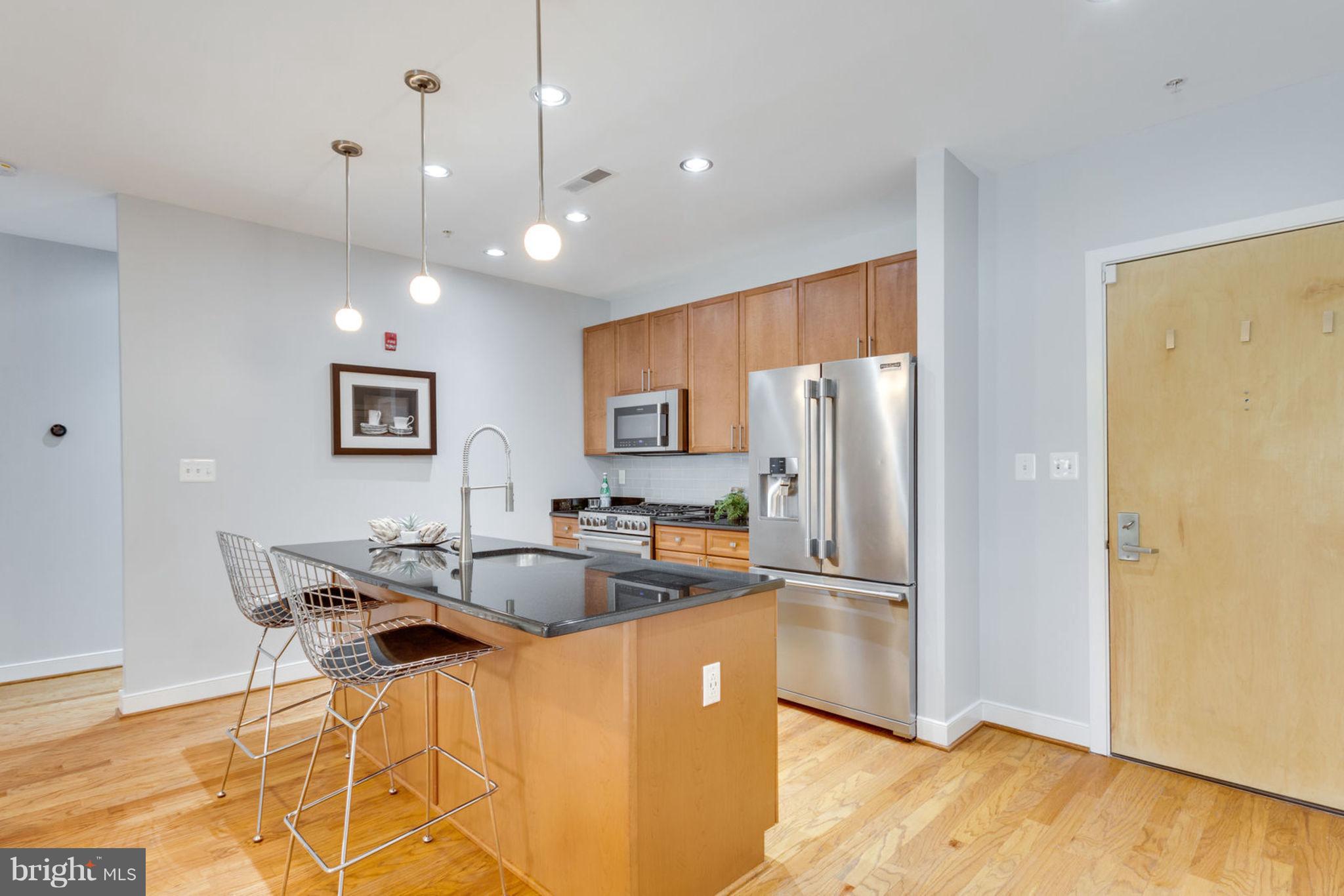 181 East Reed Avenue, Unit 109 Alexandria, VA 22305 - Photo 4 of 30 a kitchen with granite countertop a refrigerator and a sink