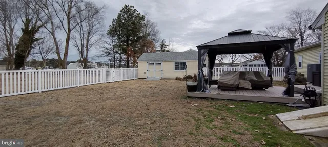 a view of a house with backyard and couches