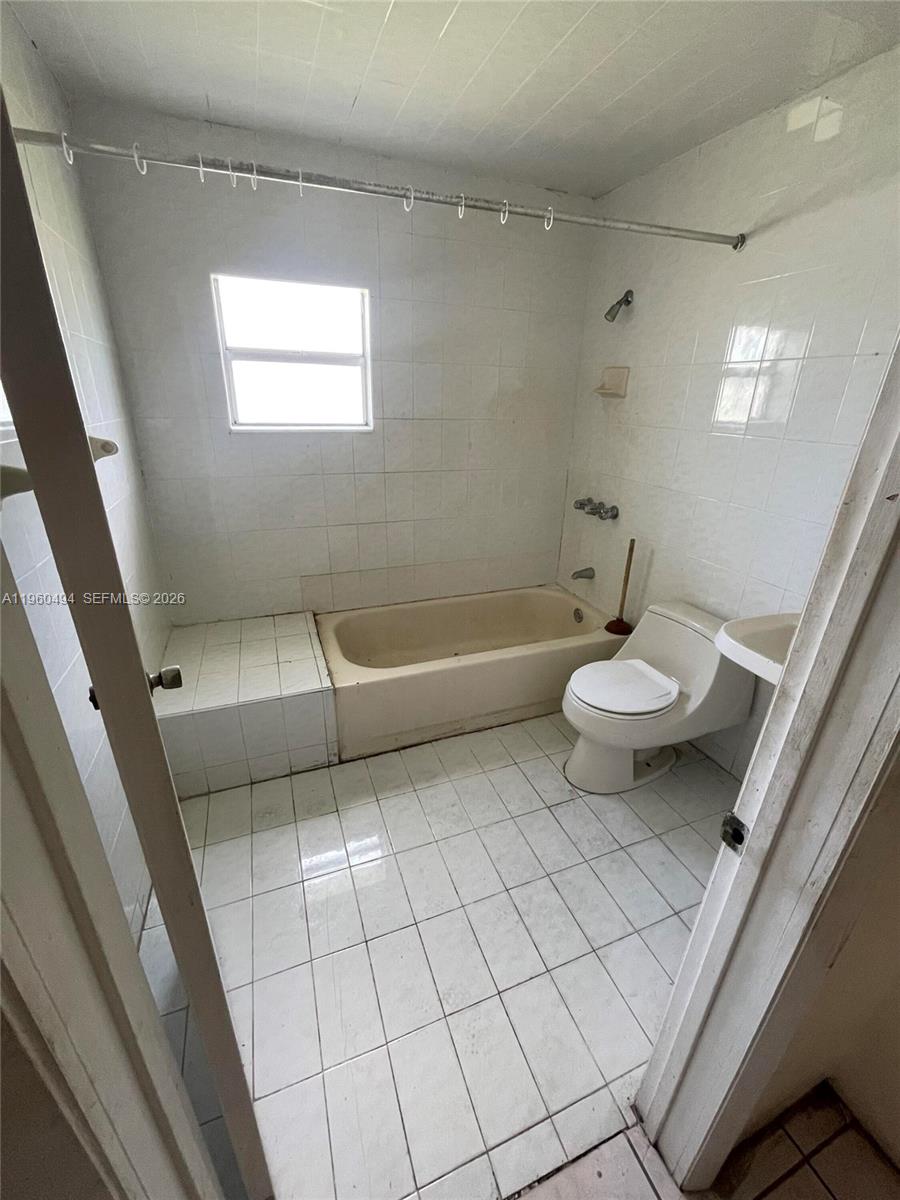 3630 Northwest 98th Street Miami, FL 33147 - Photo 18 of 38 a bathroom with a sink a toilet and bathtub