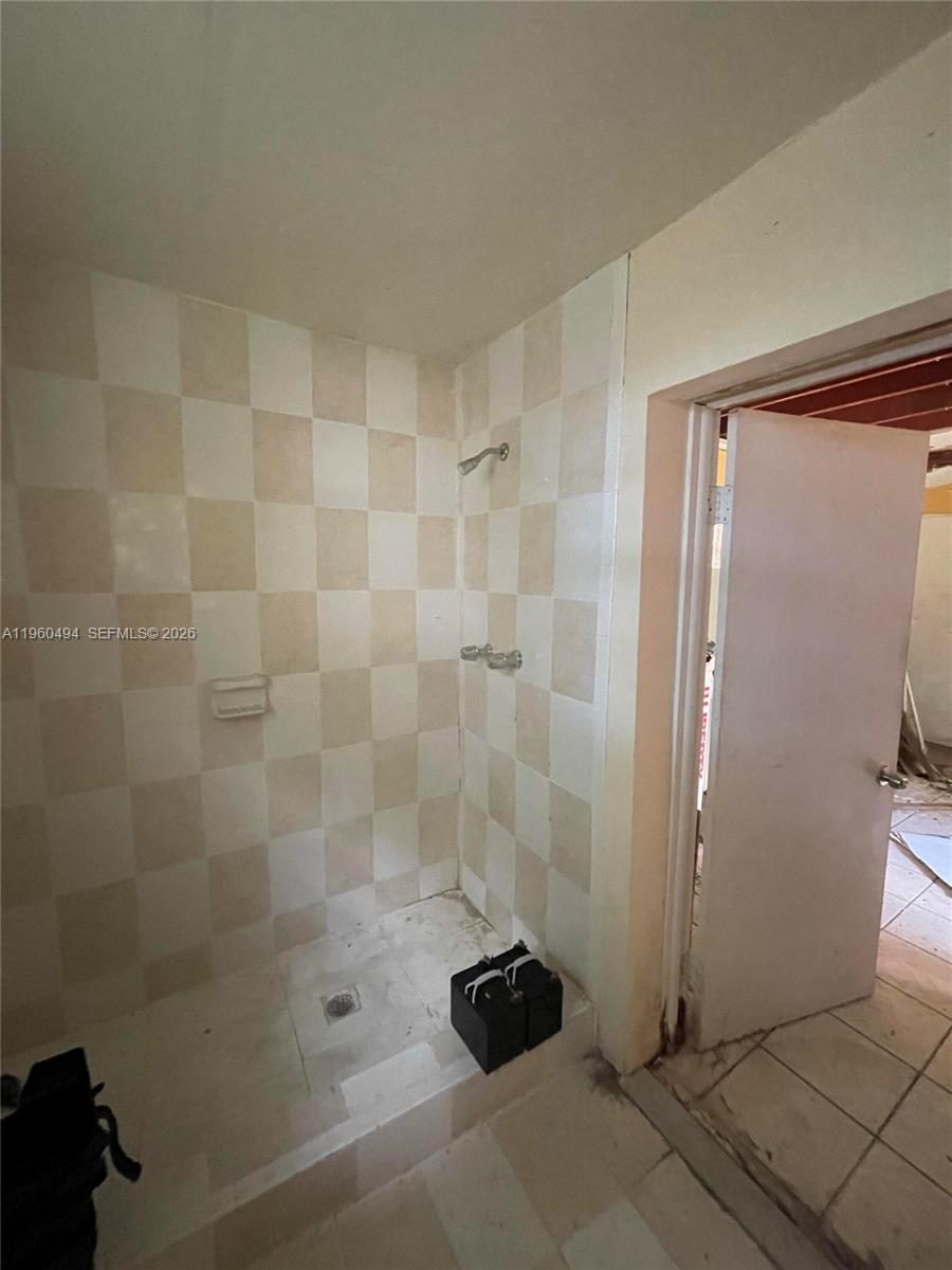 3630 Northwest 98th Street Miami, FL 33147 - Photo 37 of 38 a bathroom with a shower and a sink