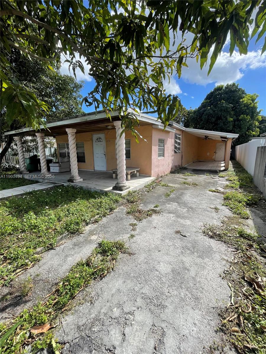 3630 Northwest 98th Street Miami, FL 33147 - Photo 6 of 38 a front view of a house with garden