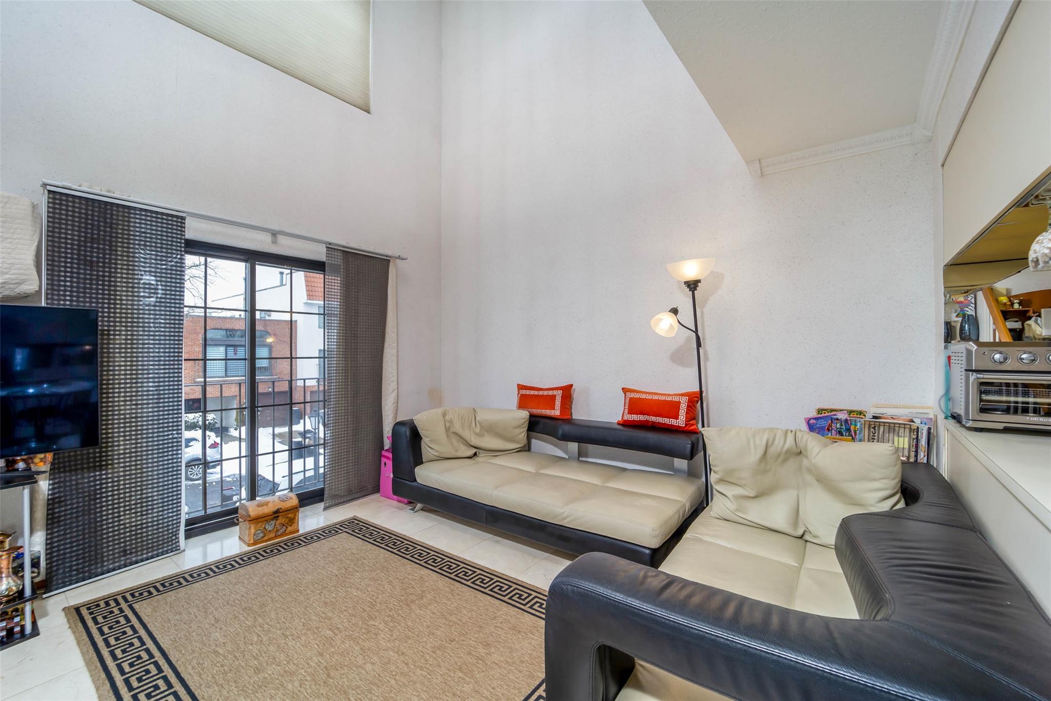 509 Julius Road Queens, NY 11356 - Photo 11 of 26 a living room with furniture and a window
