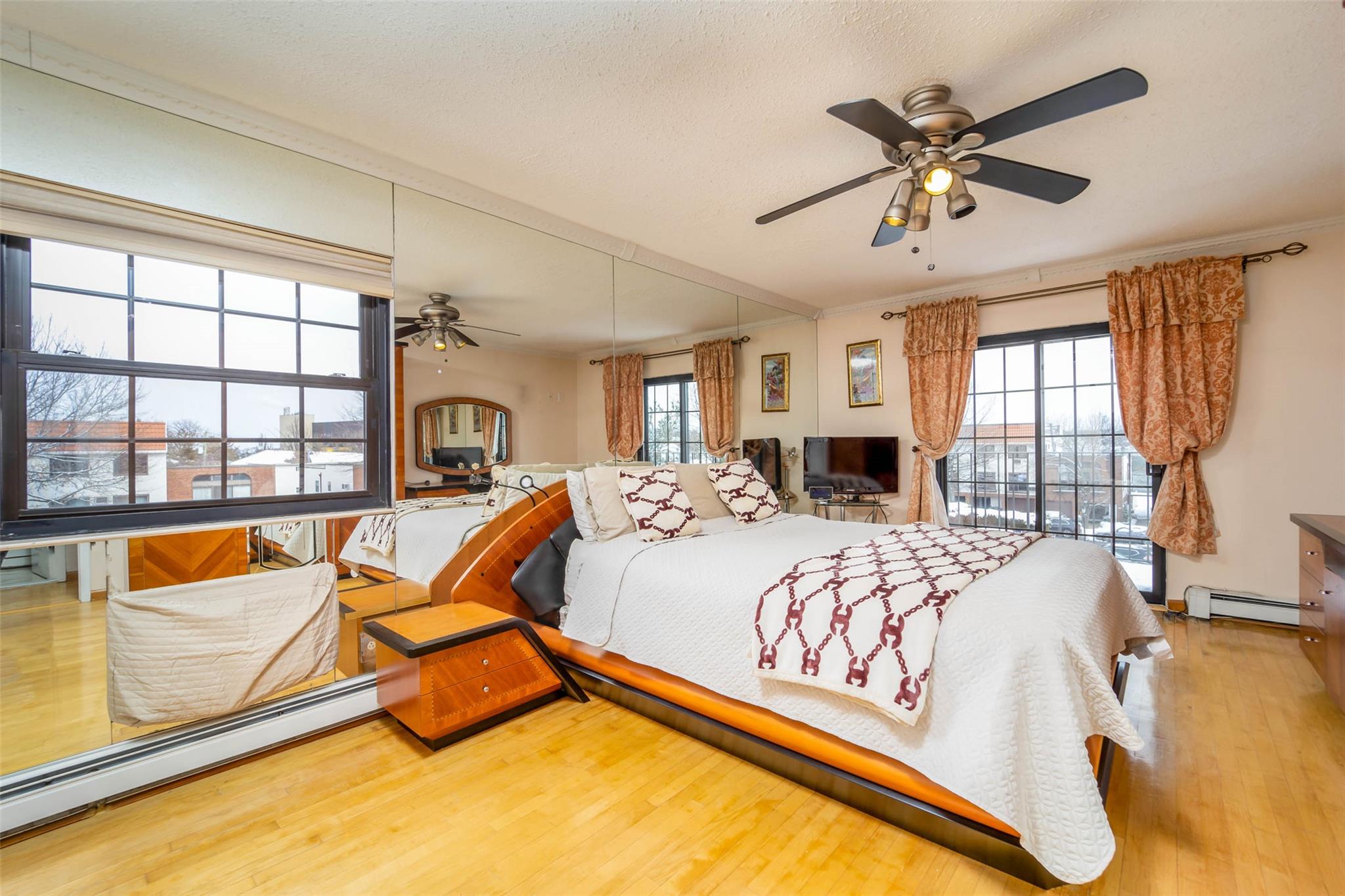 509 Julius Road Queens, NY 11356 - Photo 12 of 26 a bed sitting in a bedroom next to a window