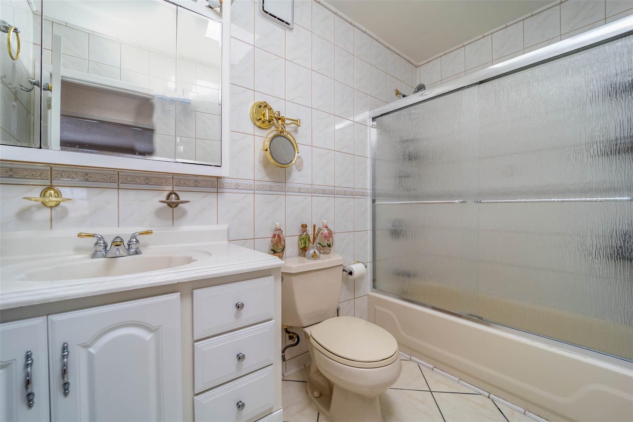 509 Julius Road Queens, NY 11356 - Photo 19 of 26 a bathroom with a sink a toilet and shower