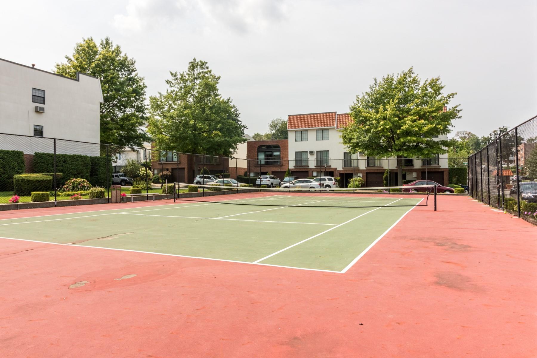 509 Julius Road Queens, NY 11356 - Photo 23 of 26 a view of a tennis ground with large trees