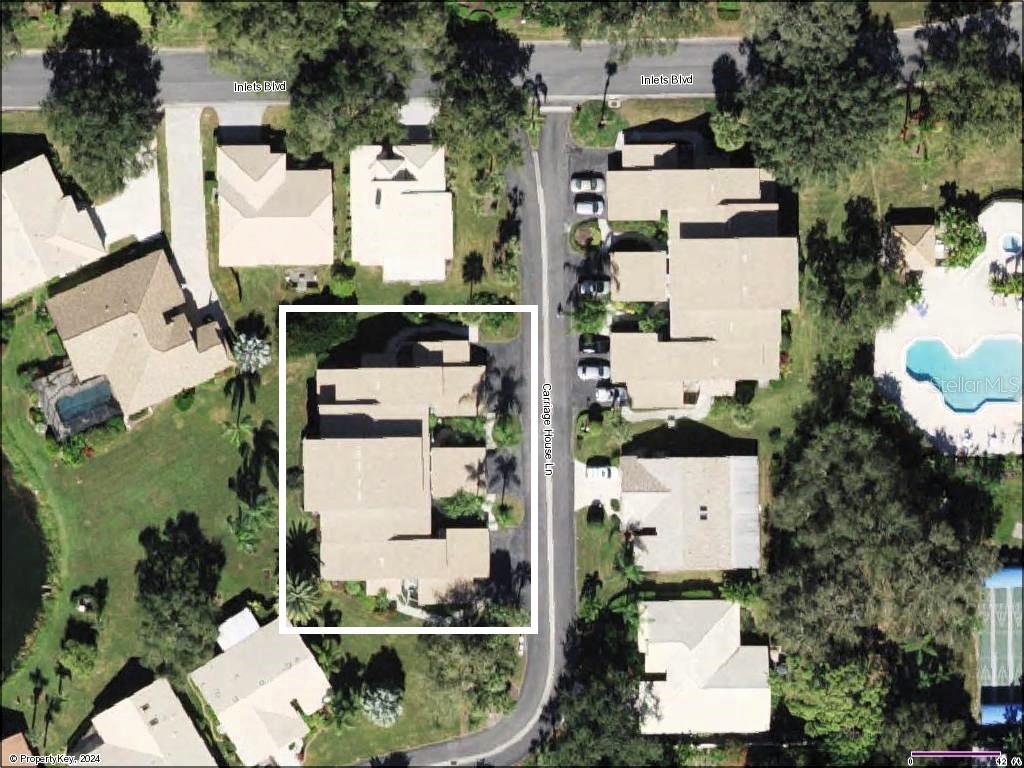 an aerial view of residential house with outdoor space and parking