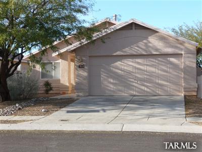 7828 South Lauder Street Tucson, AZ 85747 - Photo 1 of 11 a side view of a house with a yard