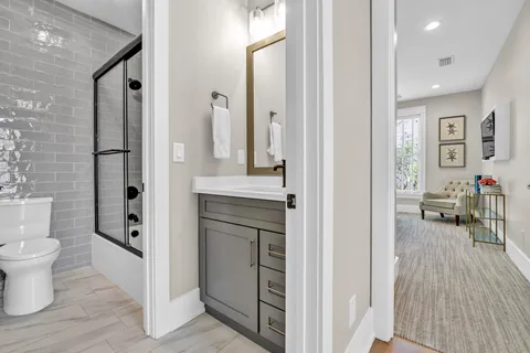 a bathroom with a toilet a sink and a mirror