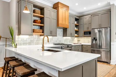 a kitchen with stainless steel appliances a sink and a refrigerator