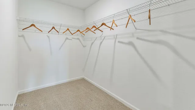 a bed room with a bed and a chair