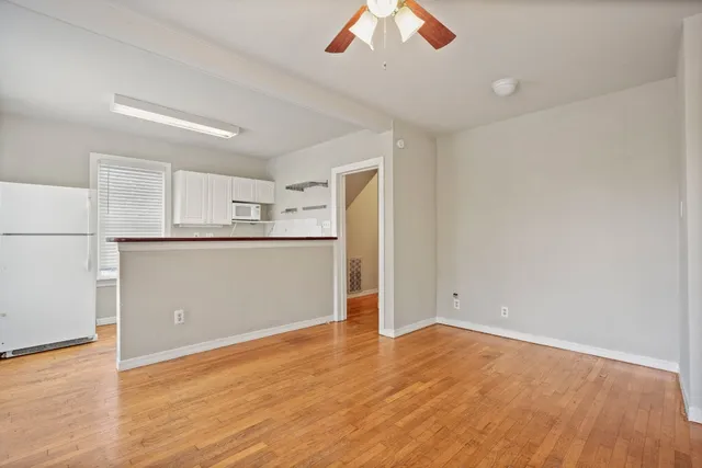 a view of a kitchen with a microwave and a refrigerator