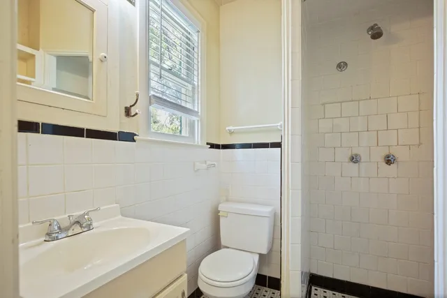 a white toilet sitting next to a bathroom sink