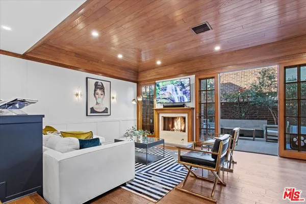 a living room with furniture and a floor to ceiling window