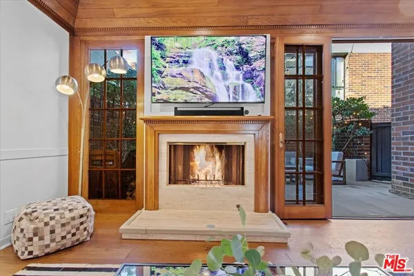 a view of a livingroom with furniture wooden floor and a large window