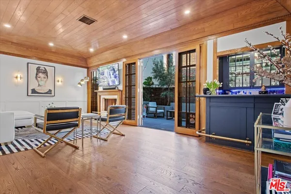a kitchen with stainless steel appliances kitchen island granite countertop a stove and white cabinets