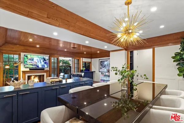a living room with furniture a fireplace and a large window
