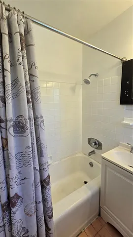 a bathroom with a bathtub and a shower