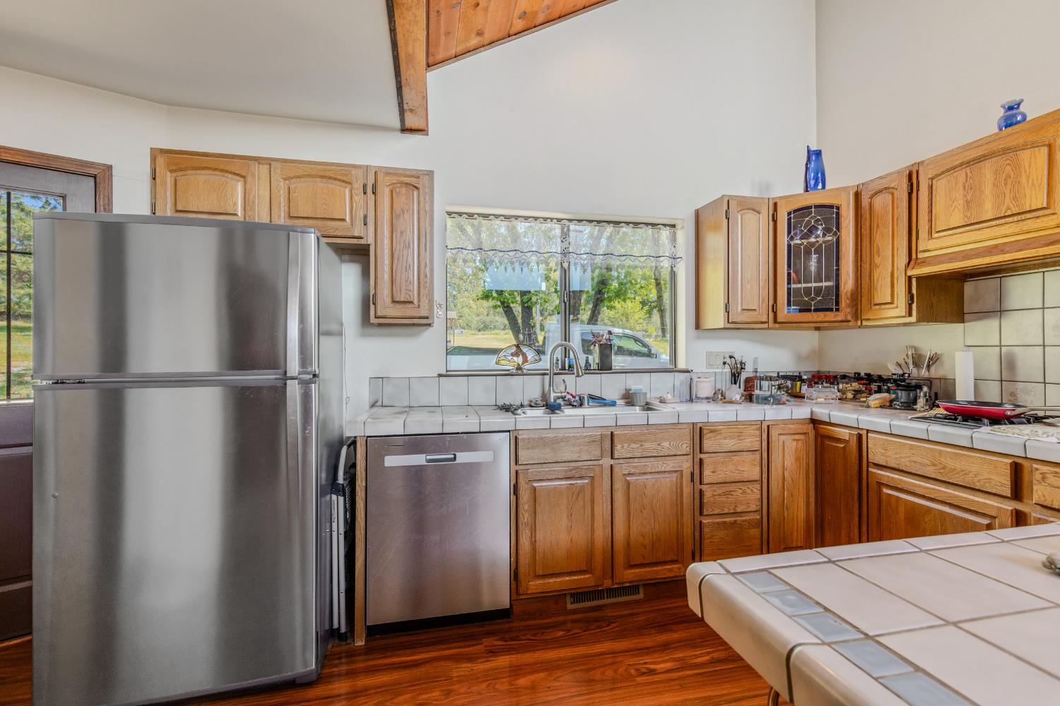 3120 Iron Mine Road Auburn, CA 95602 - Photo 15 of 38 a kitchen with stainless steel appliances granite countertop a refrigerator sink and wooden cabinets