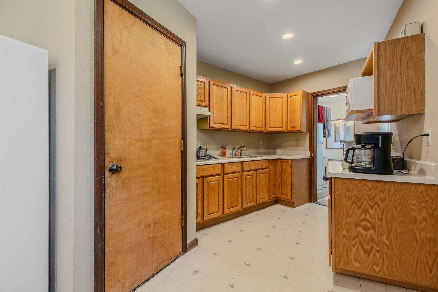 3120 Iron Mine Road Auburn, CA 95602 - Photo 24 of 38 a kitchen with a refrigerator a stove top oven a sink and cabinets