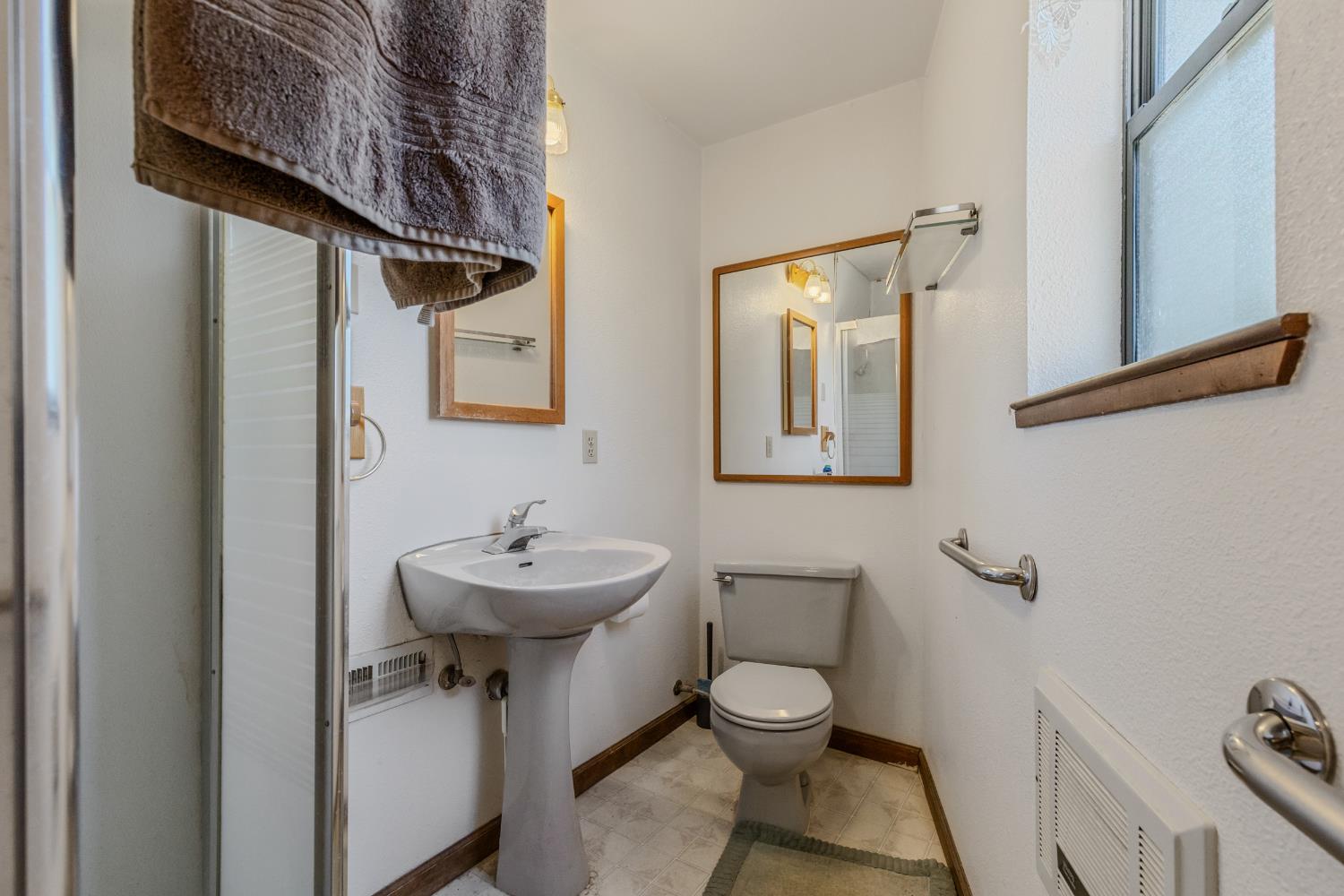 3120 Iron Mine Road Auburn, CA 95602 - Photo 25 of 38 a bathroom with a toilet a sink and mirror