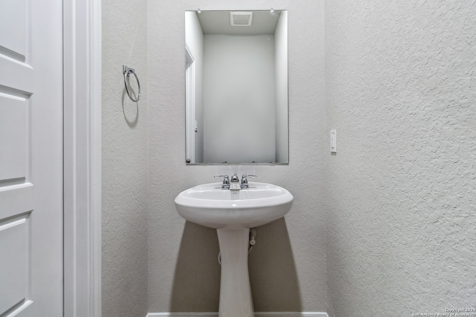 3915 Abbott Pass St. Hedwig, TX 78152 - Photo 16 of 35 a bathroom with a sink and a mirror