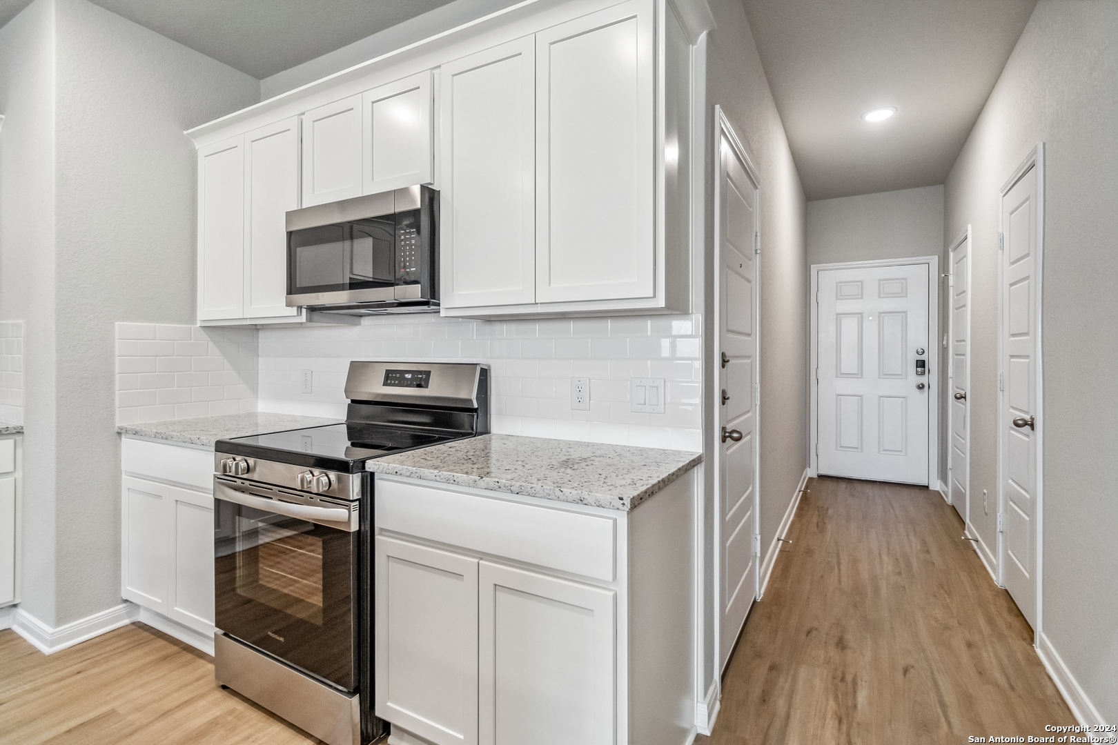 3915 Abbott Pass St. Hedwig, TX 78152 - Photo 8 of 35 a kitchen with white cabinets and stainless steel appliances