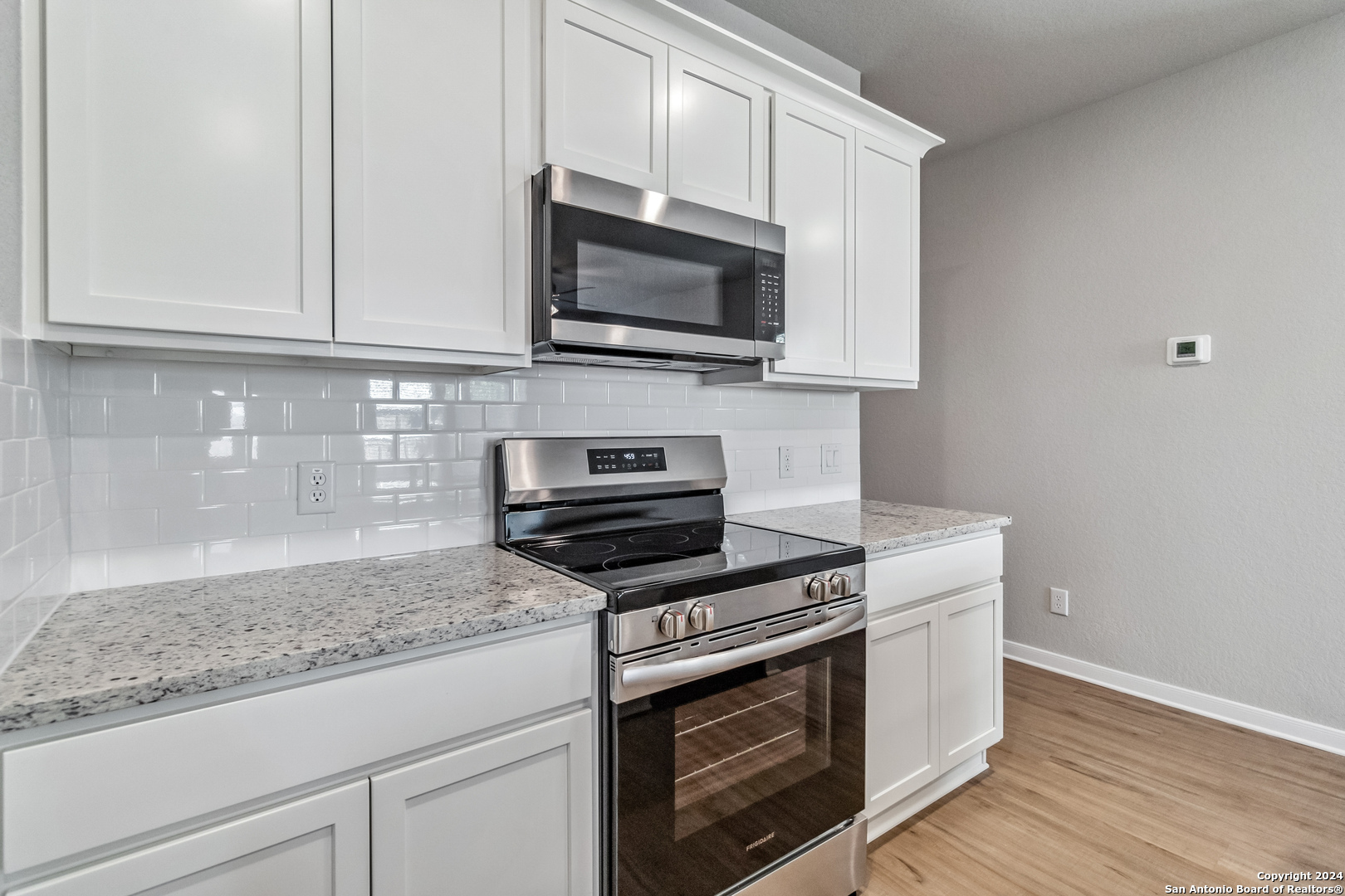 3915 Abbott Pass St. Hedwig, TX 78152 - Photo 10 of 35 a kitchen with stainless steel appliances granite countertop a stove a microwave and a sink