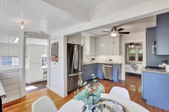 a view of a a dining room with furniture window and wooden floor