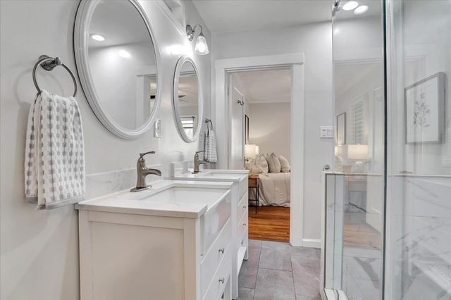 a kitchen with a sink a potted plant and cabinets