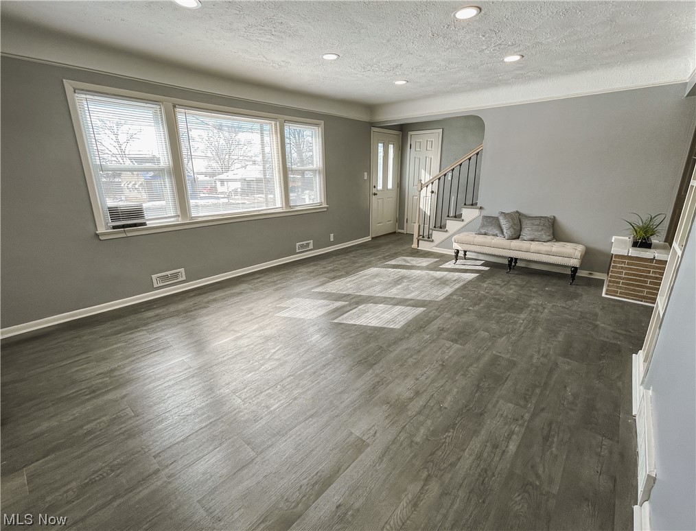 24709 Emery Road Warrensville Heights, OH 44128 - Photo 24 of 34 Spare room with dark hardwood / wood-style floors and a textured ceiling