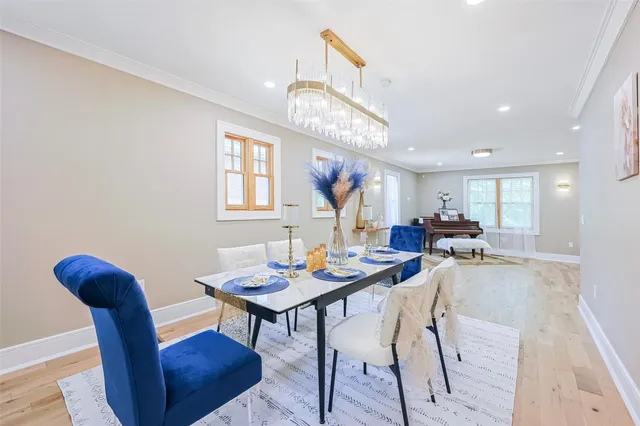a view of a dining room with furniture and a chandelier