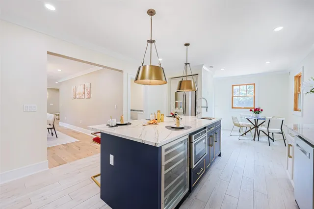 a kitchen with stainless steel appliances a sink stove and cabinets
