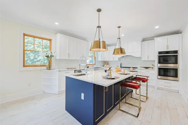 a kitchen with kitchen island granite countertop a sink counter top space and cabinets