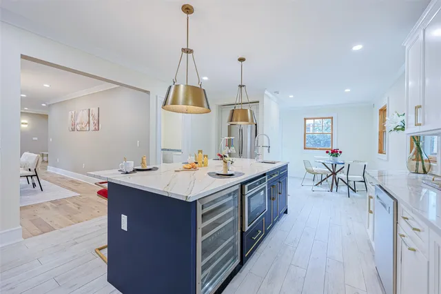 a kitchen with a sink a counter and chairs