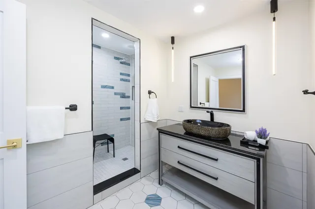a bathroom with a granite countertop sink a toilet and mirror