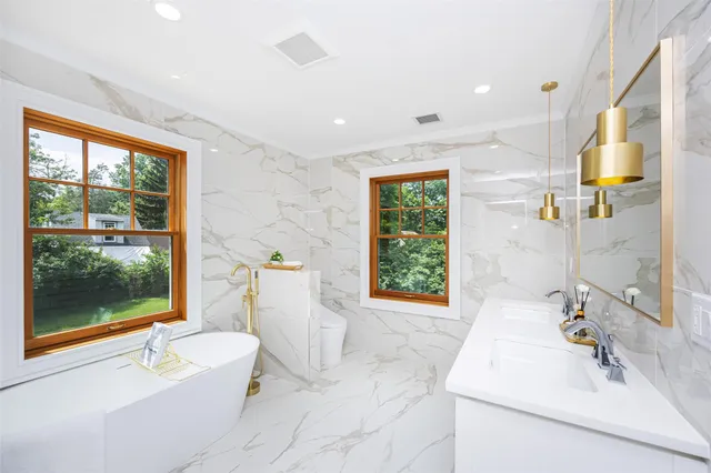 a bathroom with a double vanity sink mirror and shower