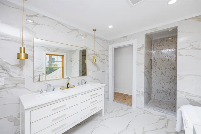 a bathroom with a sink mirror and a large window
