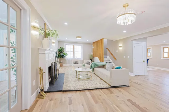 a living room with fireplace furniture and a chandelier