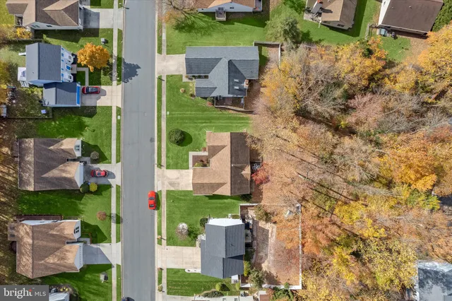 an aerial view of residential building with green space
